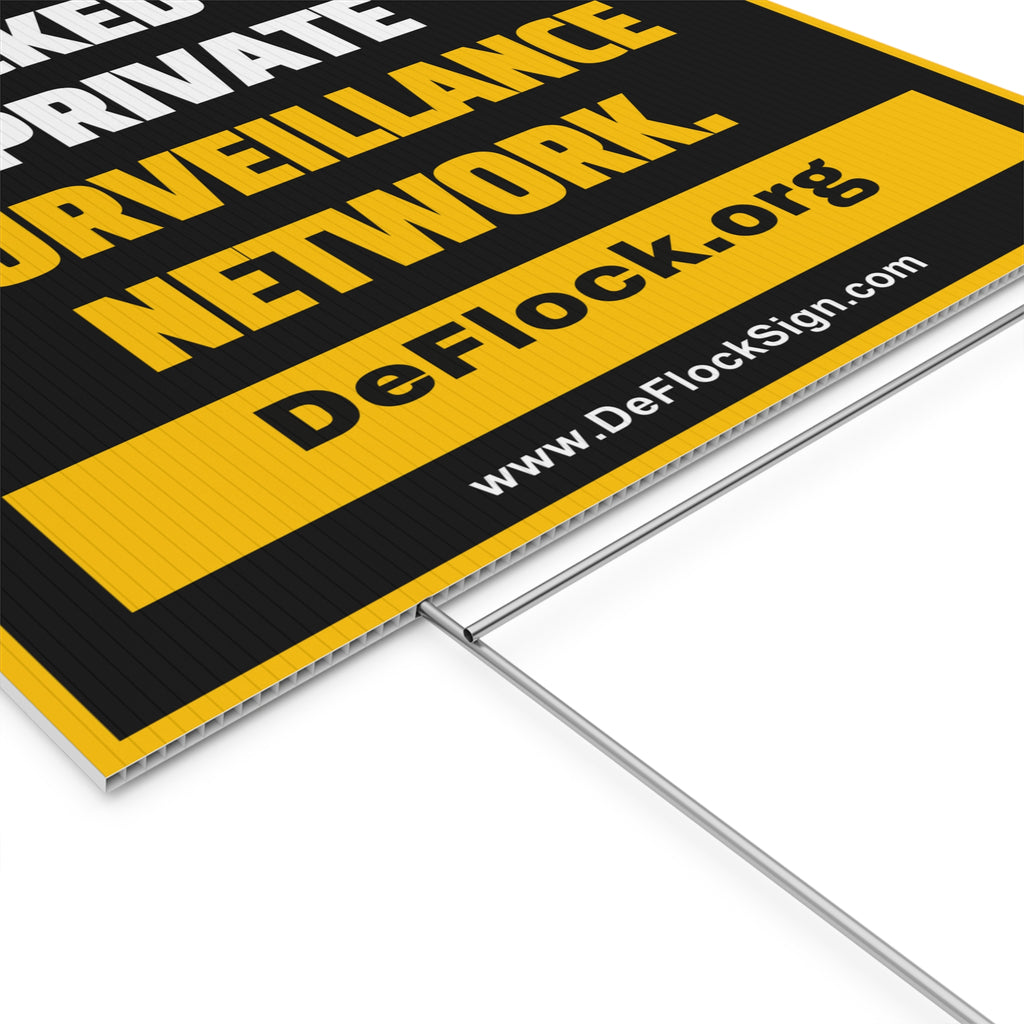 Yard sign with an arrow pointing upwards, and a message that says "You are being tracked by a private surveillance network" to indicate that above the sign is a surveillance camera.