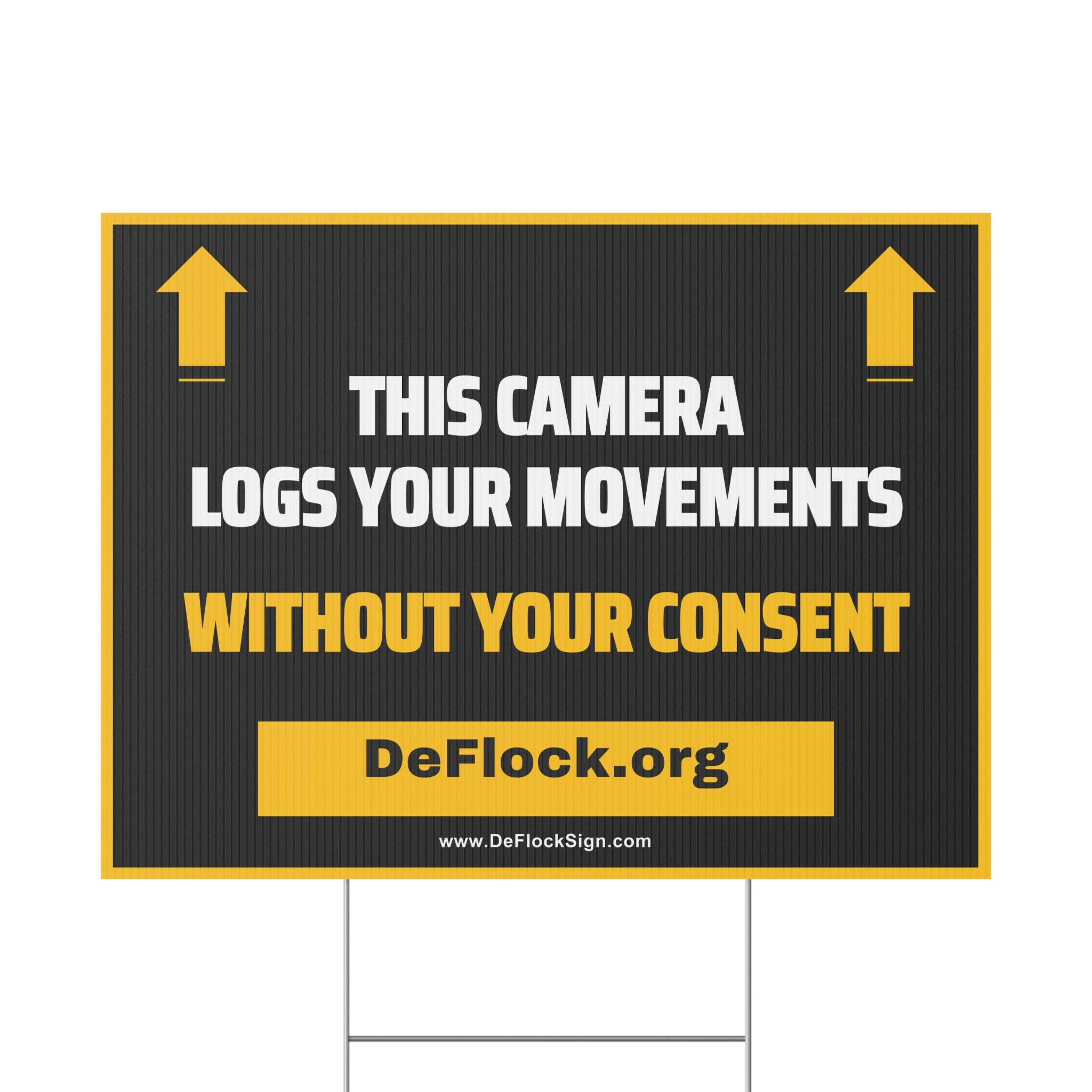 Yard sign with an arrow pointing upwards, and a message that says "This Camera Logs Your Movements Without Your Consent" to indicate that above the sign is a flock camera.