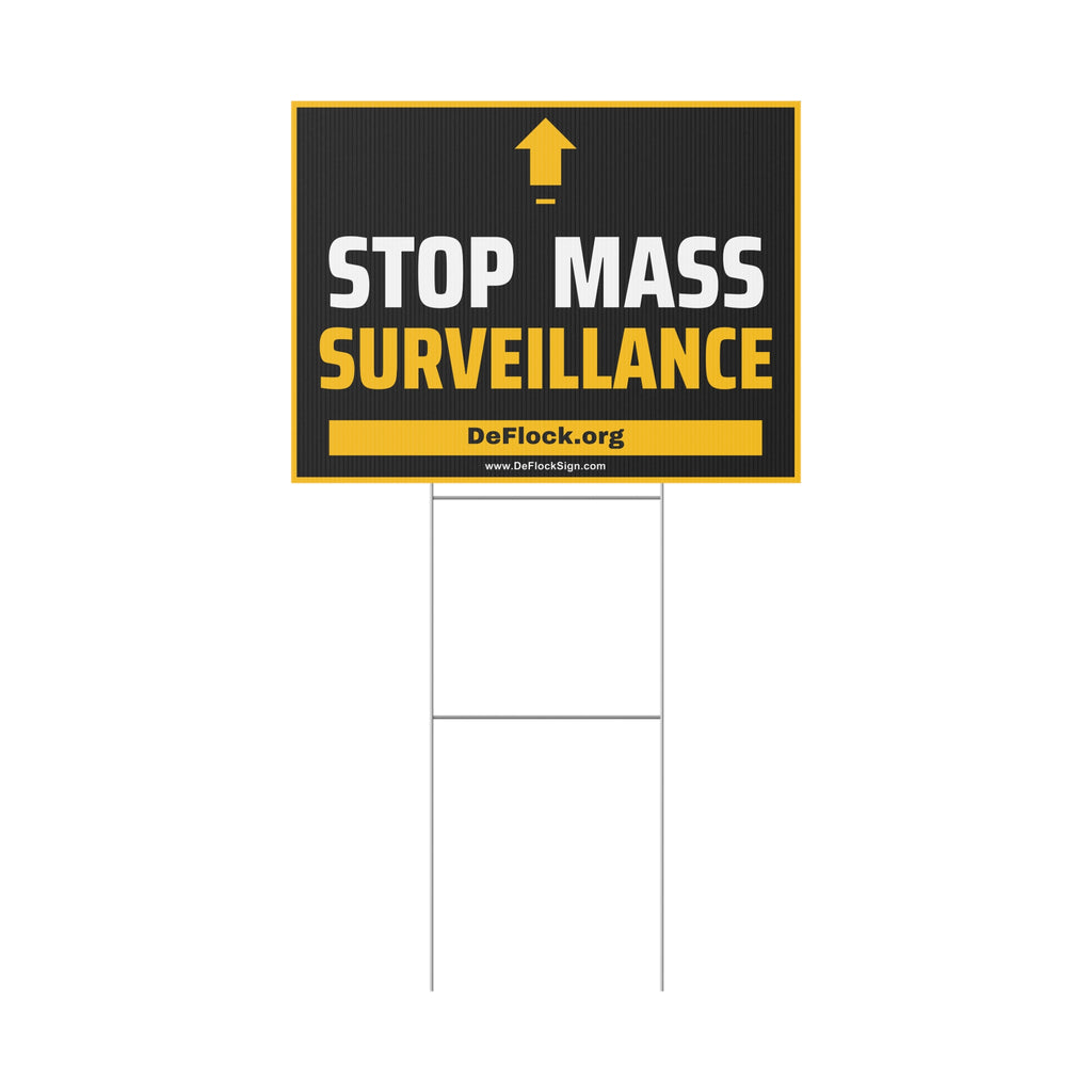 Yard sign with an arrow pointing upwards, and a message that says "Stop Mass Surveillance" to indicate that above the sign is a surveillance camera.