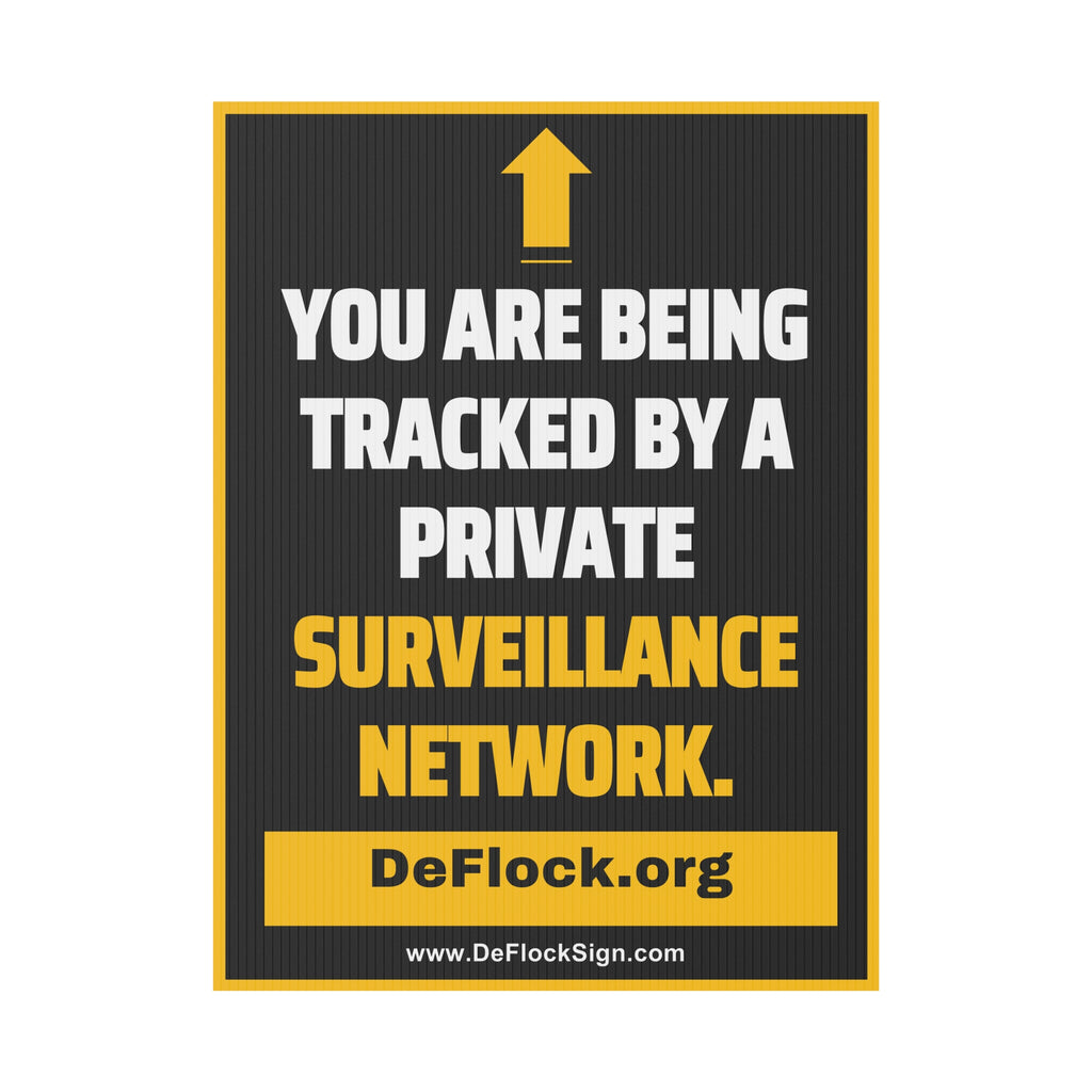 Yard sign with an arrow pointing upwards, and a message that says "You are being tracked by a private surveillance network" to indicate that above the sign is a surveillance camera.