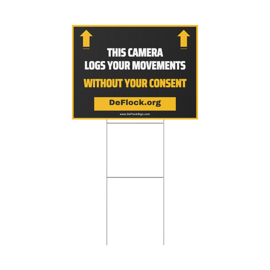 Yard sign with an arrow pointing upwards, and a message that says "This Camera Logs Your Movements Without Your Consent" to indicate that above the sign is a flock camera.