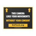 Yard sign with an arrow pointing upwards, and a message that says "This Camera Logs Your Movements Without Your Consent" to indicate that above the sign is a flock camera.