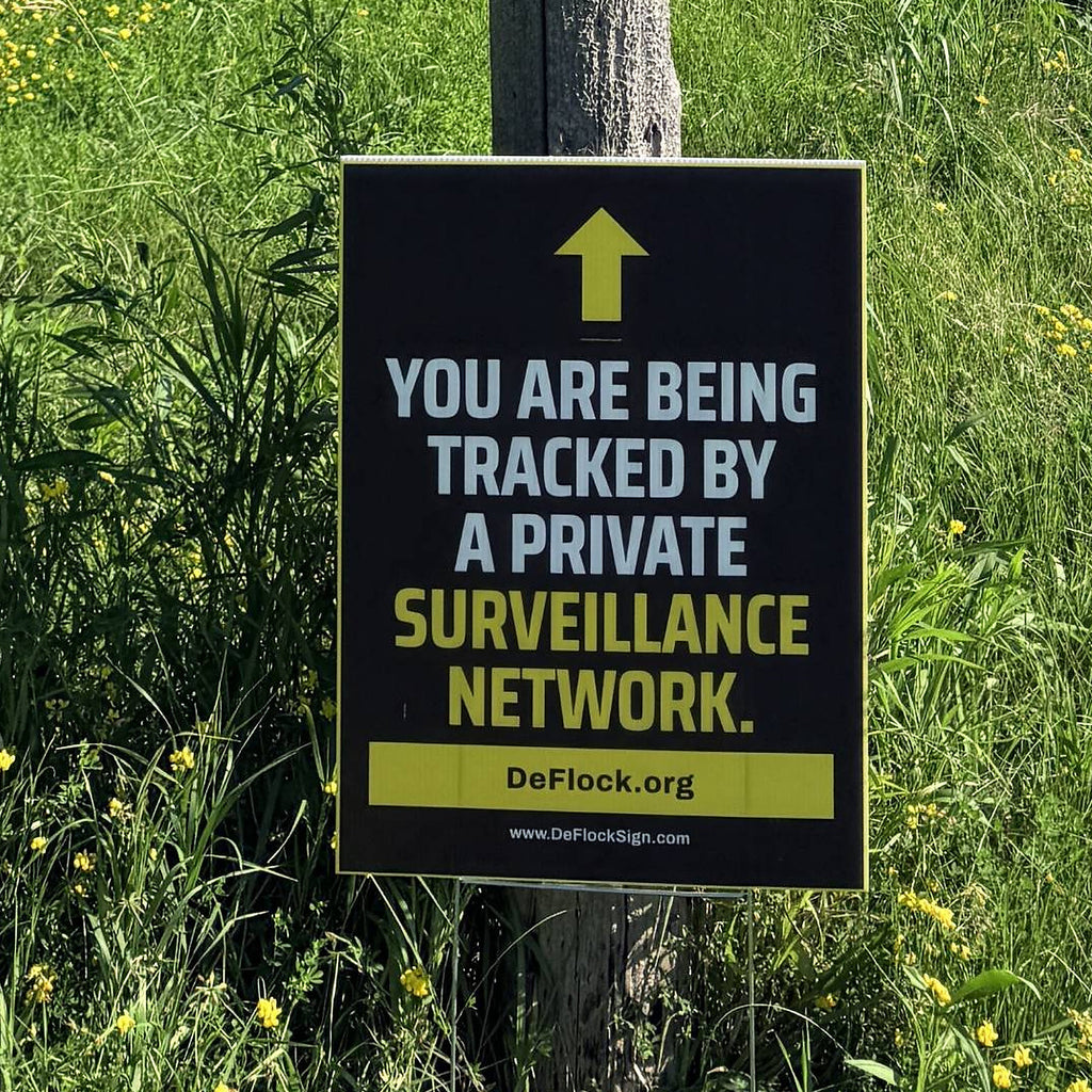Private surveillance network yard sign by DeFlock Signs with bold warning message in black and yellow colors.